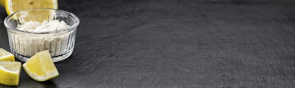 Portion of healthy Lemon powder on a slate slab (selective focus)