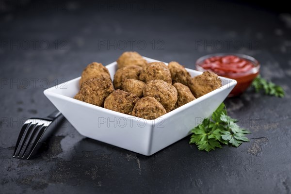 Portion of fresh homemade Meatballs on a slate slab (selective focus)