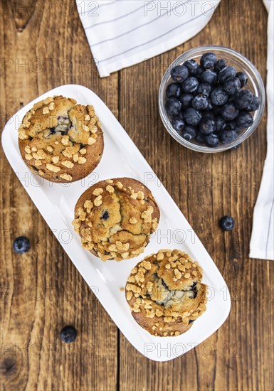 Some fresh Blueberry Muffins (selective focus, close-up shot)