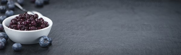 Preserved Blueberries on a vintage background as detailed close-up shot, selective focus