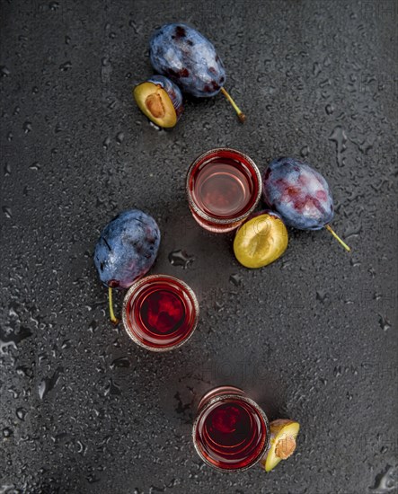 Plum Liqueur on a vintage slate slab as detailed close-up shot, selective focus