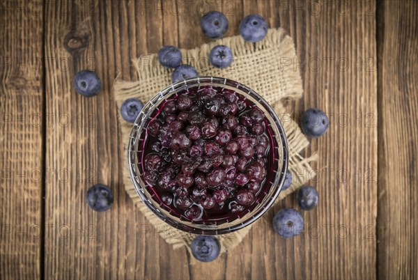 Homemade Preserved Blueberries on an wooden table as detailed close-up shot, selective focus