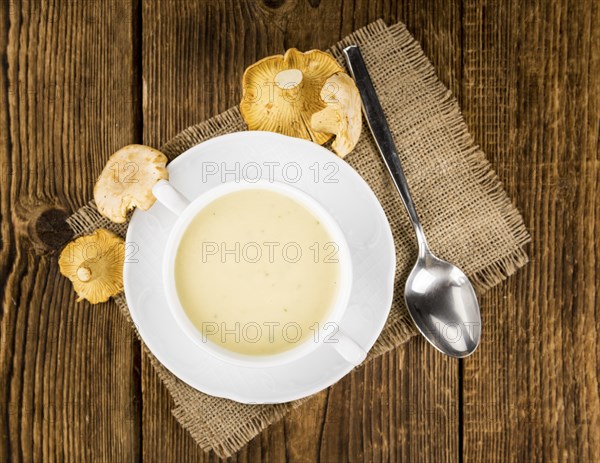 Fresh made Chanterelle Soup on a vintage background as detailed close-up shot