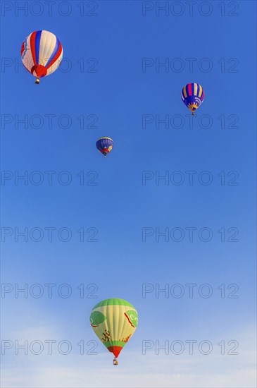 Colorful hot air balloons floating peacefully in a clear blue sky, Belarus, Minsk, Europe