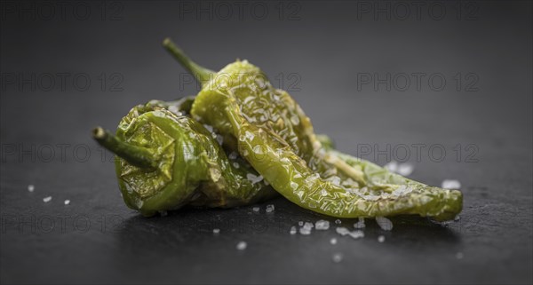 Pimientos de Padron on a vintage background as detailed close-up shot, selective focus