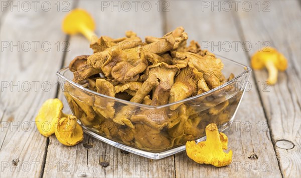 Canned chanterelles on a vintage background as detailed close-up shot, selective focus