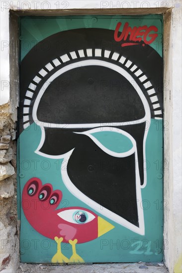 Greek helmet and bizarre bird, graffiti by street artist Uneg, Plaka historic centre, Athens,