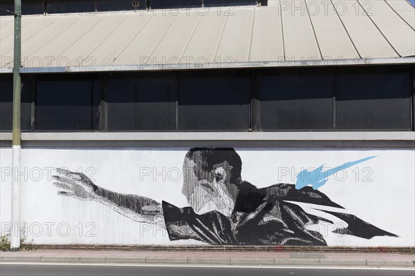 Man with outstretched arm, surreal mural in black and white by Greek street artist INO, Gazi