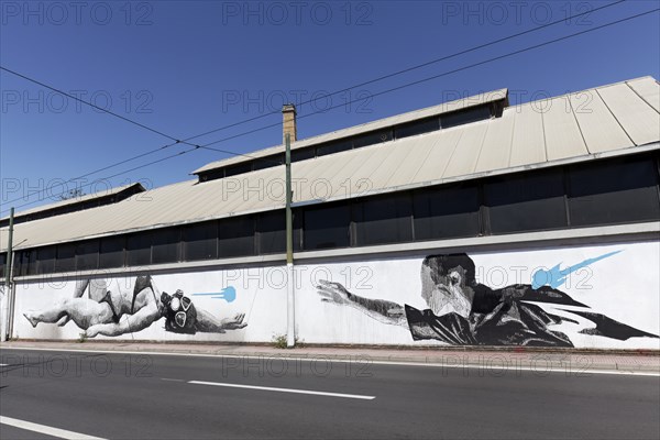 Man reaching for woman in bikini with diving mask, surreal mural in black and white by Greek street
