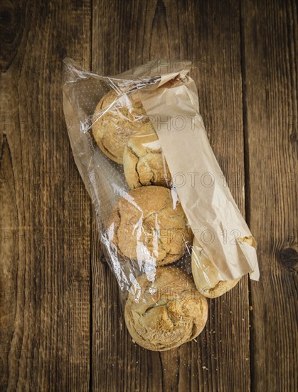 Fresh made German Buns on an old and rustic wooden table, selective focus, close-up shot
