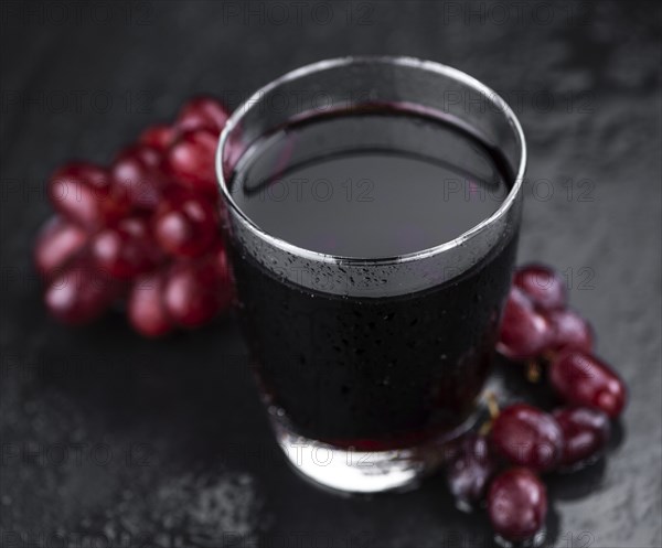 Some fresh Red Grape Juice (selective focus, close-up shot)