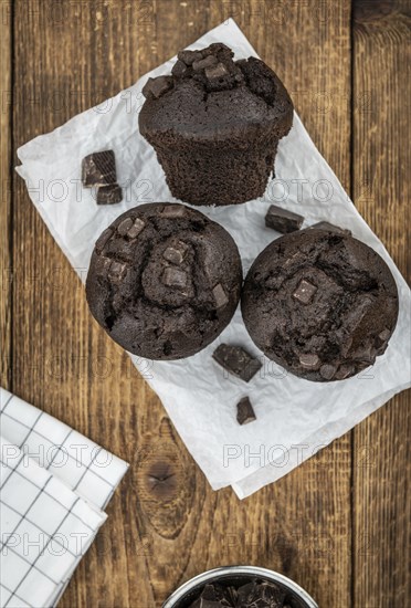 Some fresh Chocolate Muffins (selective focus, close-up shot)