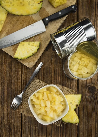 Preserved Pineapple pieces on a vintage background as detailed close-up shot, selective focus