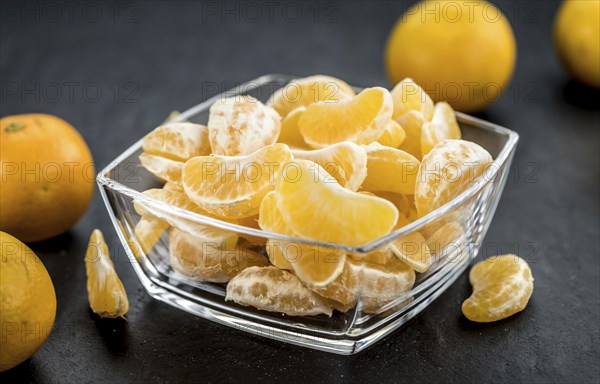 Fresh Tangerine pieces (selective focus) on a vintage background