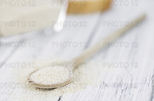 Some Bread Crumbs on a vintage wooden table (selective focus, close-up shot)