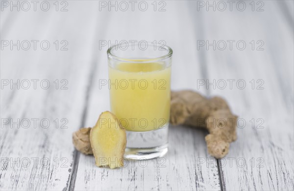 Portion of fresh Ginger Juice (selective focus, close-up shot)