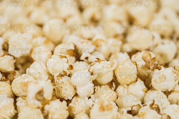 Fresh made Popcorn on a vintage background as detailed close-up shot
