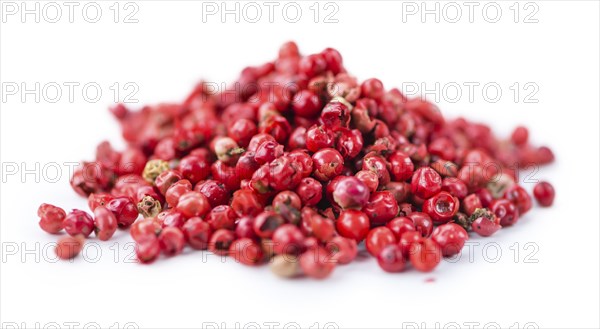 Portion of Pink Peppercorns as detailed close-up shot isolated on white background