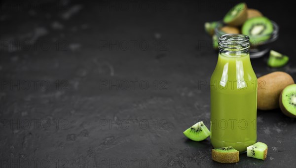 Kiwi Smoothie (selective focus) on an old and vintage background (homemade)