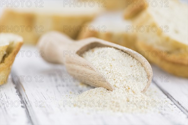 Old wooden table with fresh Breadcrumbs (close-up shot, selective focus)