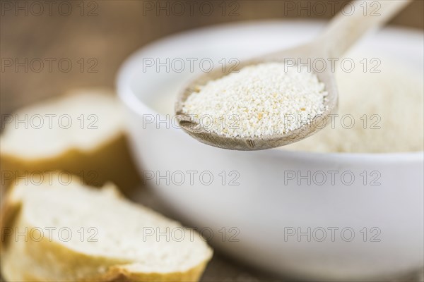 Some Bread Crumbs on a vintage wooden table (selective focus, close-up shot)
