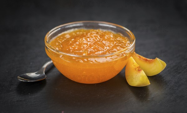 Portion of fresh Peach Jam close-up shot, selective focus
