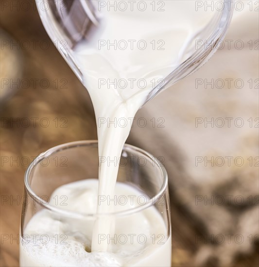 Wooden table with Oat Milk (detailed close-up shot, selective focus)