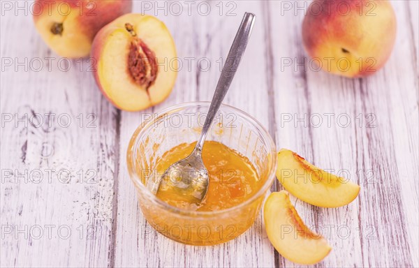 Portion of fresh Peach Jam close-up shot, selective focus