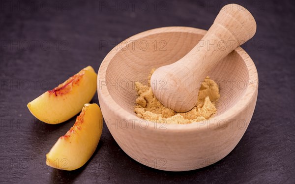 Peach powder on a vintage slate slab as detailed close-up shot, selective focus