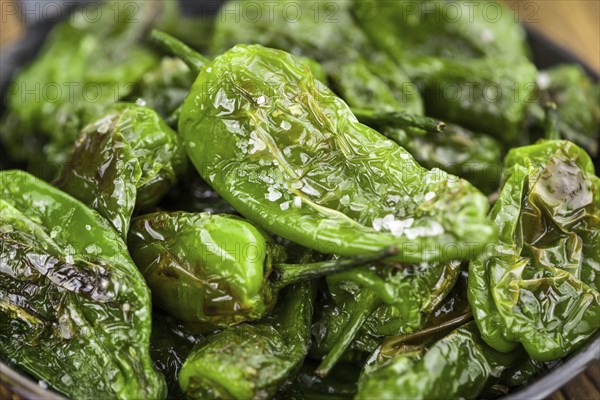 Portion of fresh Pimientos de Padron close-up shot, selective focus
