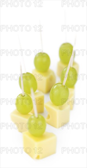 Cheese blocks with grapes isolated on white background (partyfood)
