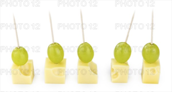 Cheese blocks with grapes isolated on white background (partyfood)