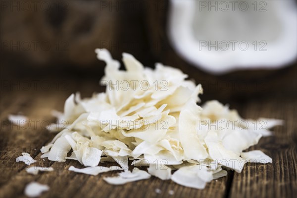 Coconut Chips (fresh) as detailed close-up shot, selective focus)
