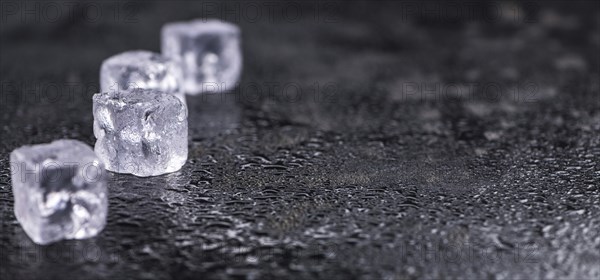 Some melting Ice cubes on a vintage slate slab (selective focus)