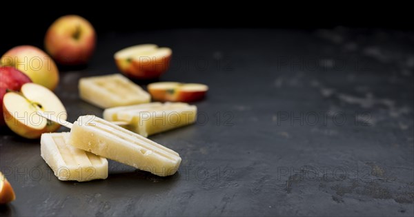 Fresh made Apple Popsicles (selective focus, close-up shot) on a vintage background