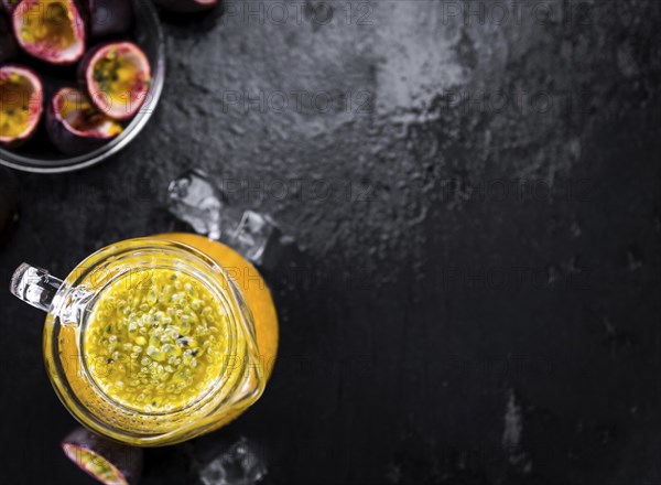 Maracuja Juice on a vintage looking slate slab (selective focus)