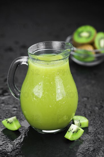 Kiwi Smoothie (selective focus) on an old and vintage background (homemade)