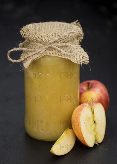 Portion of homemade Applesauce (selective focus, close-up shot) on vintage background
