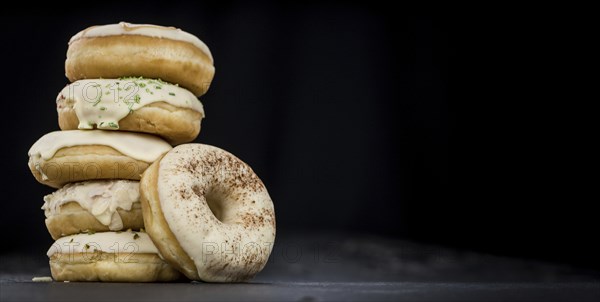 Some fresh made white chocolate Donuts (selective focus, close-up shot)