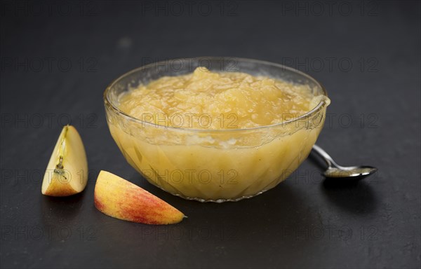 Slate slab with homemade Applesauce (close-up shot, selective focus)