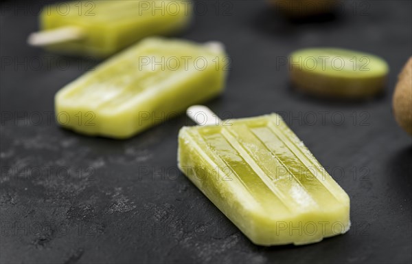 Kiwi Popsicles on a vintage looking slate slab (selective focus)