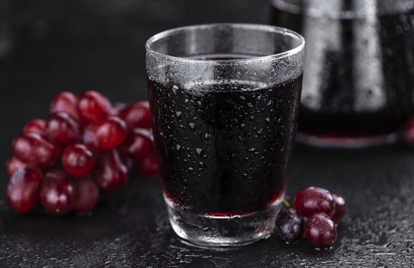 Some fresh Red Grape Juice (selective focus, close-up shot)