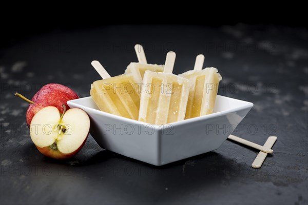 Fresh made Apple Popsicles (selective focus, close-up shot) on a vintage background