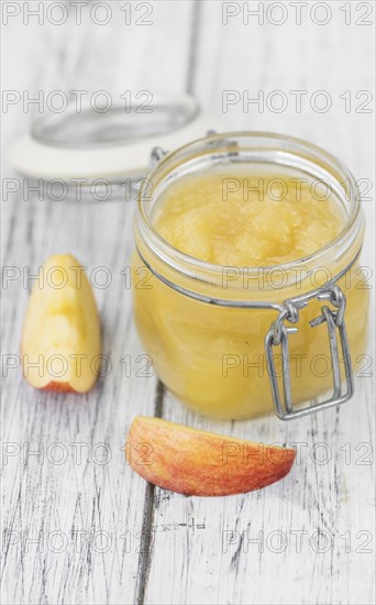 Homemade Applesauce (selective focus, close-up shot) on vintage background with some fresh fruits