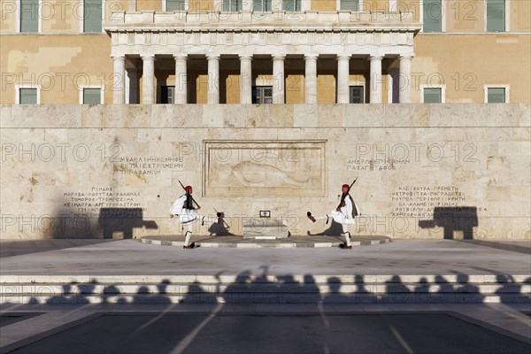 Two Evzones in traditional dress in front of the parliament building, Tomb of the Unknown Soldier,