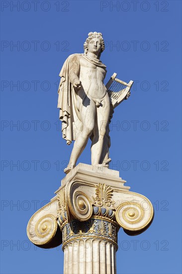 Column with statue of Apollo in front of the Academy of Athens, blue sky, sculptor Leonidas Drosis,