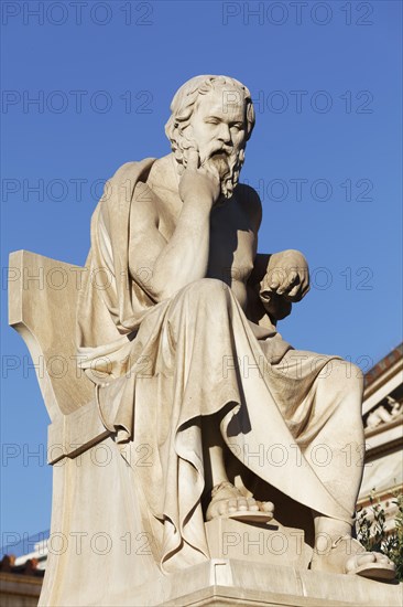 Sculpture of the Greek philosopher Socrates in front of the Academy of Athens, blue sky, sculptor
