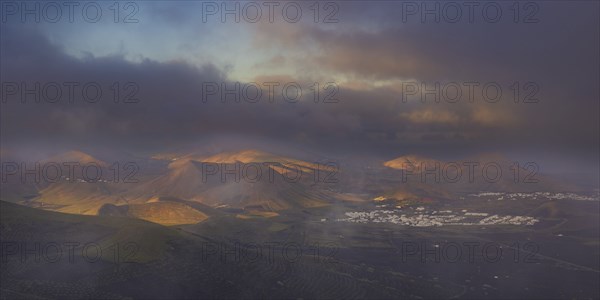 Panorama at sunrise from Montana de Guardilama to the wine-growing region of La Geria, with the