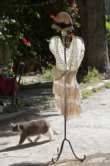 Clothes rack with summer dress in the morning light, placed in front of a fashion boutique, Plaka
