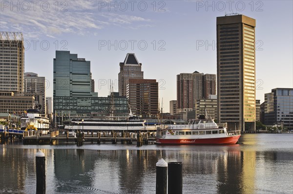 The skyline and boats in the early morning in the inner Harbor, Baltimore Maryland USA